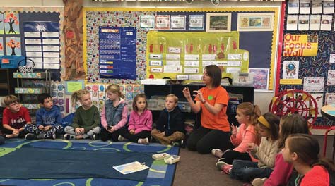 SSU graduate student giving talk to group of school children